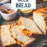 Close up shot of sliced loaf of the best beer bread recipe with text title overlay