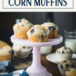 Pink stand of blueberry cornbread muffins with text title box at top