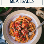 Overhead shot of a fork in a bowl of chicken meatballs with text title box at top.