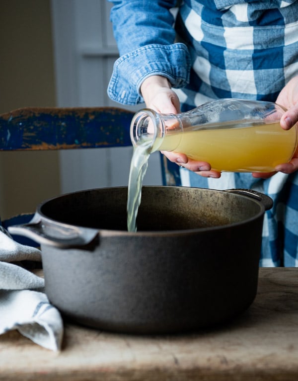 Pouring broth into a pot