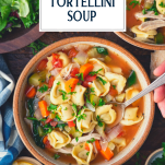 Hands eating a bowl of chicken tortellini soup with text title overlay