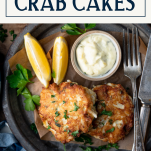Close overhead shot of a plate of how to make crab cakes with text title box at top