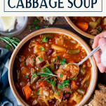 Hands eating a bowl of slow cooker cabbage soup with text title box at top.