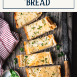 Sliced loaf of garlic bread with text title box at top