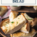 Close up side shot of the best garlic bread recipe in a bowl with text title box at top