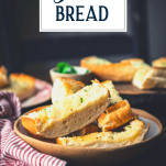 Homemade garlic bread on a table with text title overlay