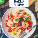 Close overhead shot of a bowl of Italian baked shrimp with text title overlay