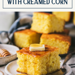 Side shot of a piece of cornbread with creamed corn on a plate with text title box at top.