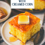 Butter and honey on top of a piece of cornbread with creamed corn and text title overlay.
