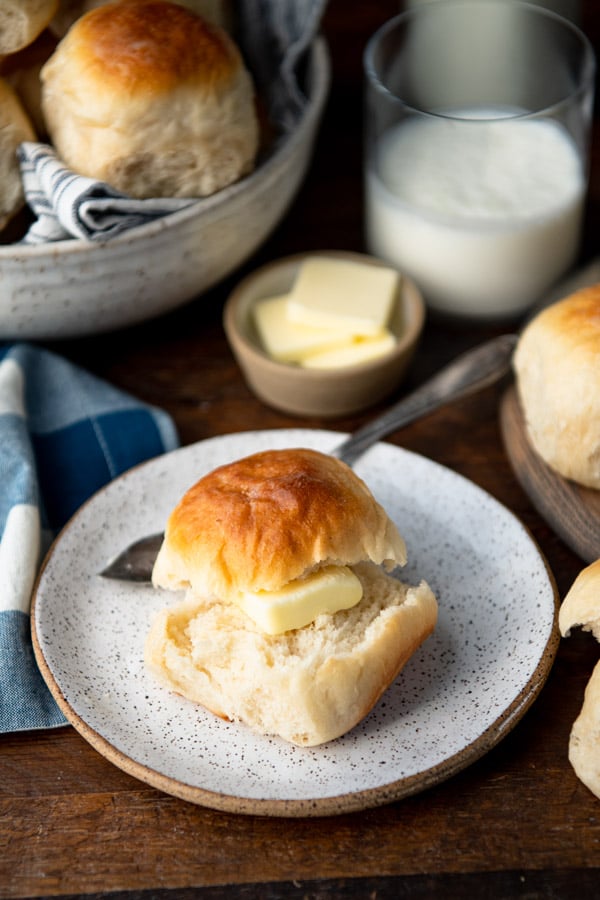 Dinner roll on a plate with butter