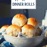 Side shot of a bowl of homemade dinner rolls with text title overlay