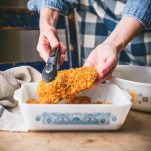 Coating chicken in corn flakes crumb mixture