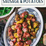Overhead image of a plate of sausage and potatoes recipe on a wooden table with text title box at top