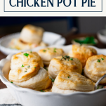 Side shot of chicken pot pie with biscuits with text title box at top