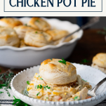 Side shot of a plate of chicken pot pie with biscuits and text title box at top