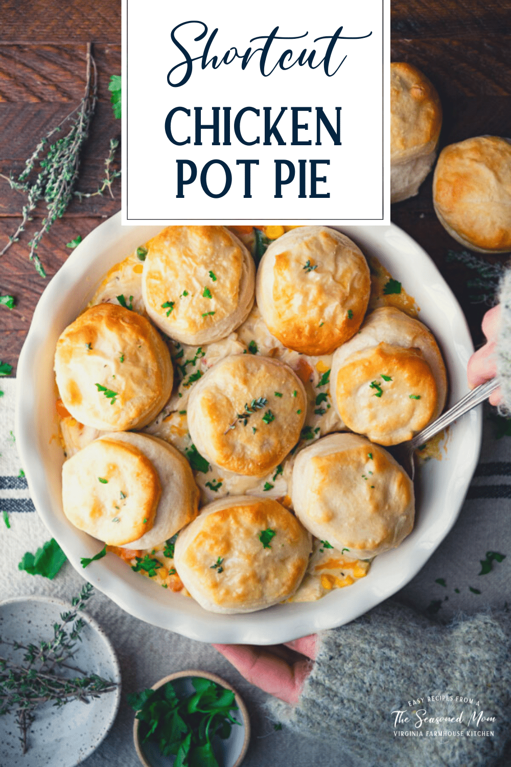 Overhead shot of hands serving chicken pot pie with biscuits with text title overlay