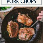 Hands serving baked stuffed pork chops from a skillet with text title box at top