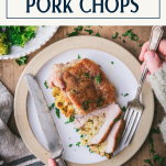 Overhead shot of hands eating a stuffed pork chop recipe on a plate with text title box at top