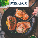 Serving baked stuffed pork chops from a skillet with text title overlay