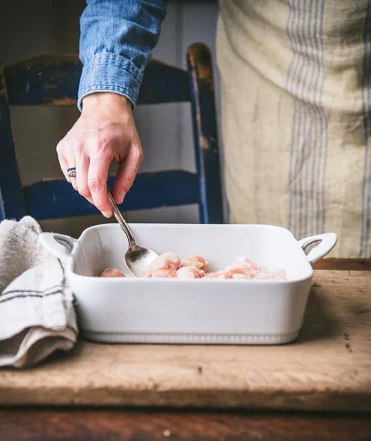 Stirring together chicken with cornstarch.