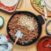 Cooking the ground beef in a skillet.