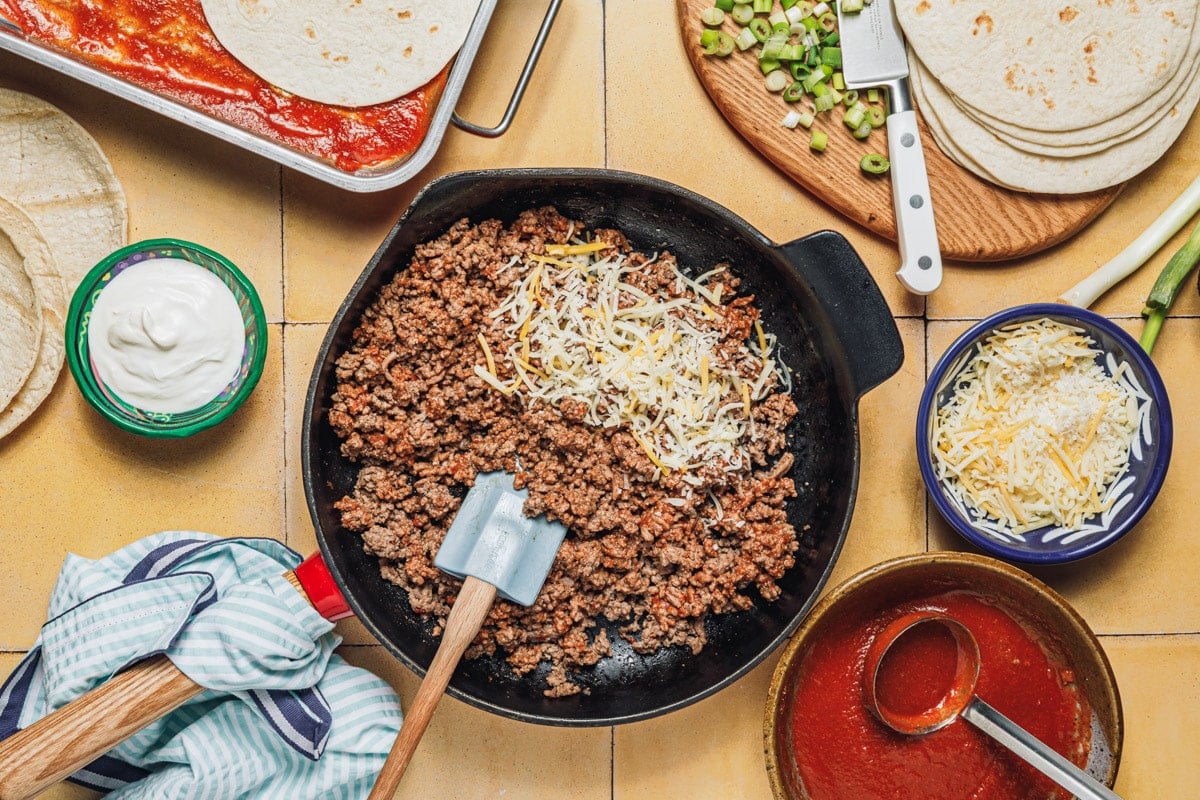 Cooking the ground beef in a skillet.
