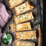 Overhead shot of the best garlic bread recipe served on a wooden tray