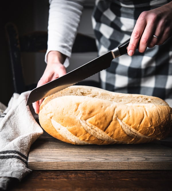 Slicing a loaf of Italian bread