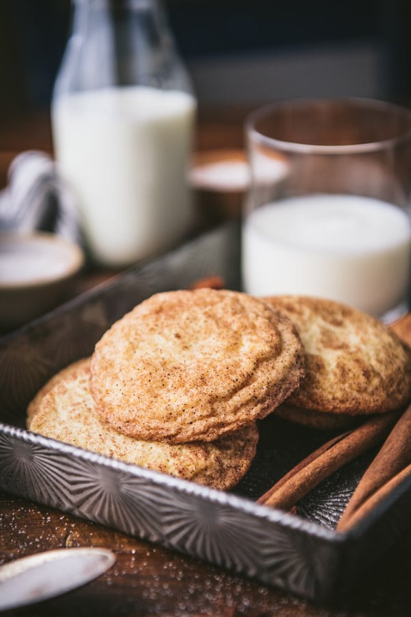 Close up tray of snickerdoodle cookies with a glass of milk