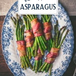 Blue and white platter of bacon wrapped asparagus with text title overlay