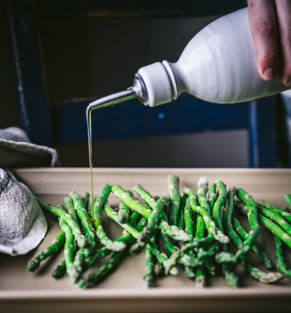 Drizzling asparagus with olive oil