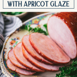 Close up side shot of sliced baked ham with glaze on a tray with text title box at top