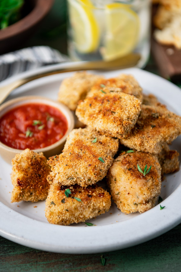 Plate of crispy Parmesan chicken nuggets with marinara for dipping