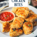 Close up side shot of a plate of crispy baked chicken nuggets with text title overlay
