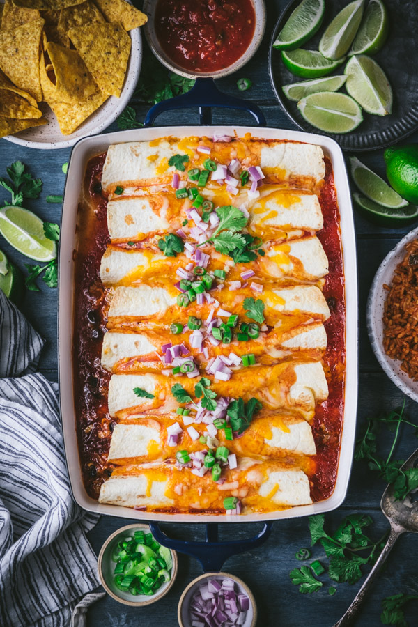 Overhead shot of a tray of ground beef enchiladas on a dinner table