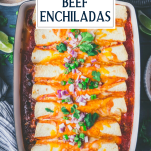 Overhead image of a tray of the best beef enchilada recipe with text title overlay
