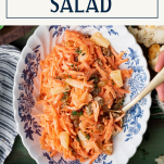 Overhead shot of a bowl of carrot raisin salad with text title box at top