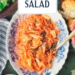 Serving carrot salad from a blue and white bowl with text title overlay