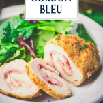 Plate of baked chicken cordon bleu with salad and text title overlay