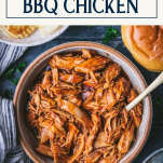 Overhead shot of crockpot bbq chicken in a bowl with text title box at top
