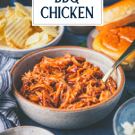 Side shot of a bowl of crockpot bbq chicken with text title overlay