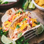 Close up shot of the best crockpot chicken tacos recipe with tortilla chips on the side