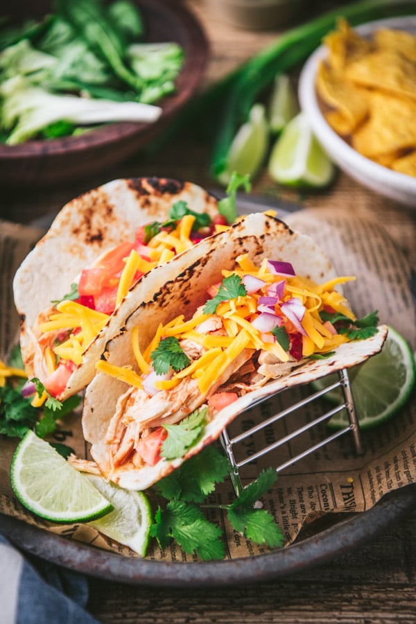 Close up shot of the best crockpot chicken tacos recipe with tortilla chips on the side