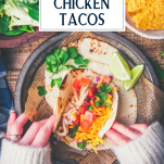 Overhead shot of hands eating crockpot chicken tacos with text title overlay