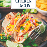 Close up side shot of crockpot chicken tacos with text title overlay