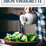 Drizzling dijon vinaigrette on a salad with text title box at top