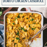 Overhead shot of hands holding a dish of ranch chicken casserole with text title box at top