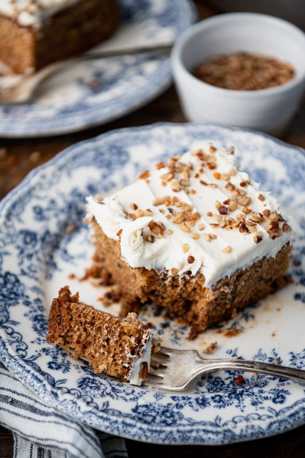 Close up shot of a blue and white plate with a slice of the best easy carrot cake recipe