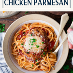 Hands eating a bowl of chicken parmesan with pasta and text title box at top