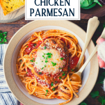 Overhead shot of hands eating an easy chicken parmesan recipe with text title overlay
